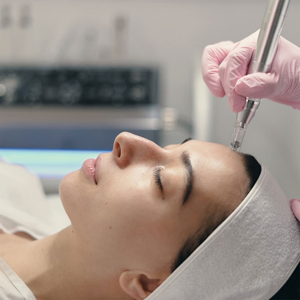 Clinician performing a facial skin treatment on a patient