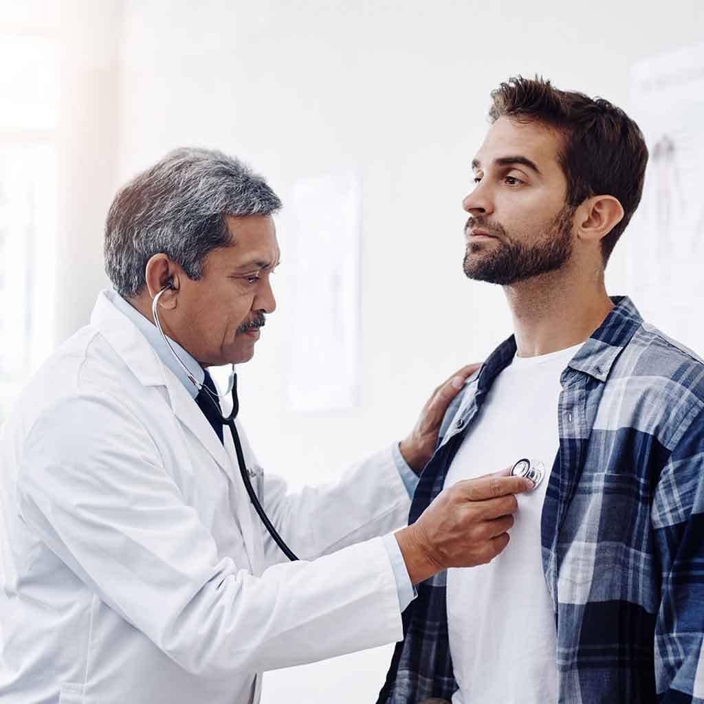 Physician listening to a patient's chest with a stethoscope