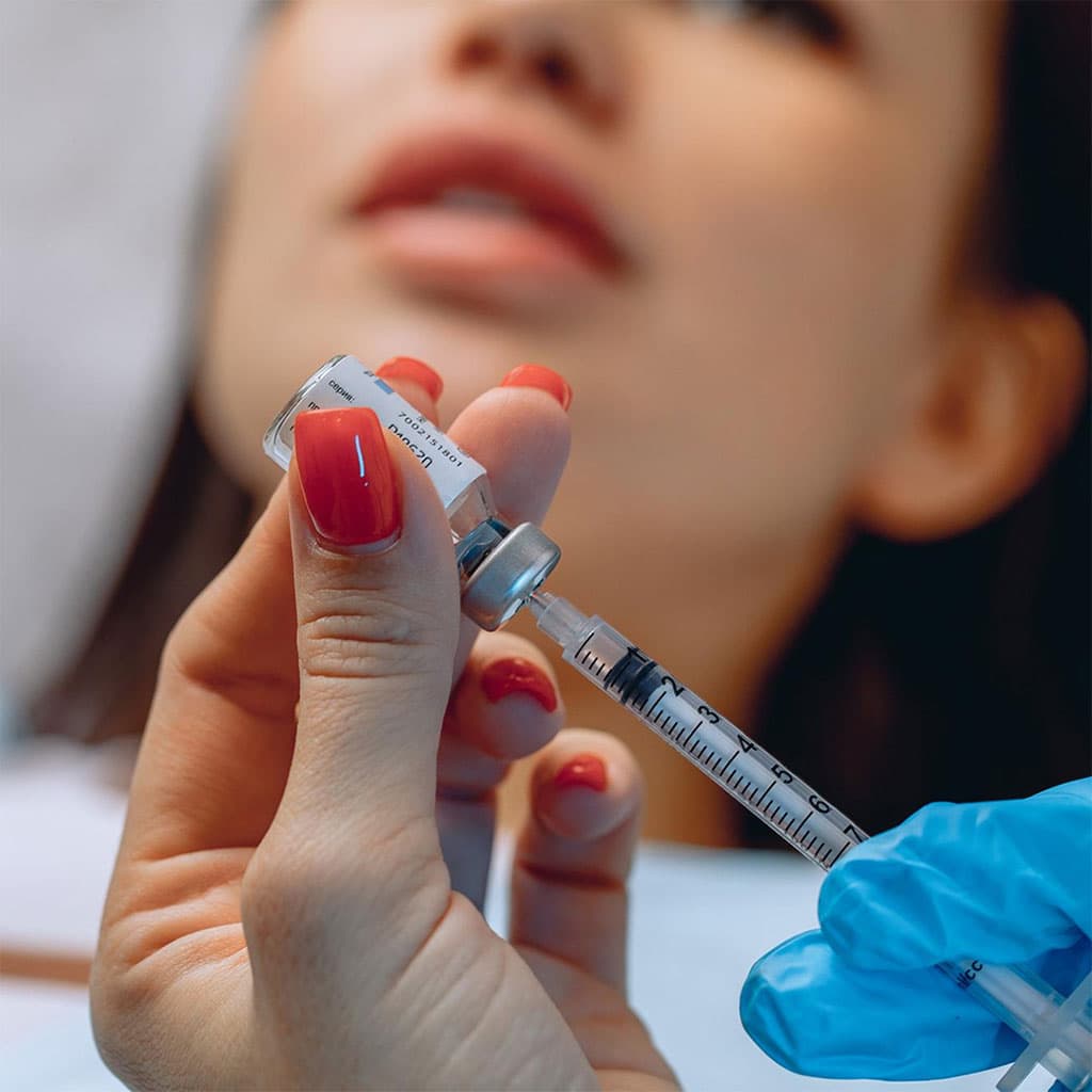 Close-up of a clinician preparing a precise Botox injection