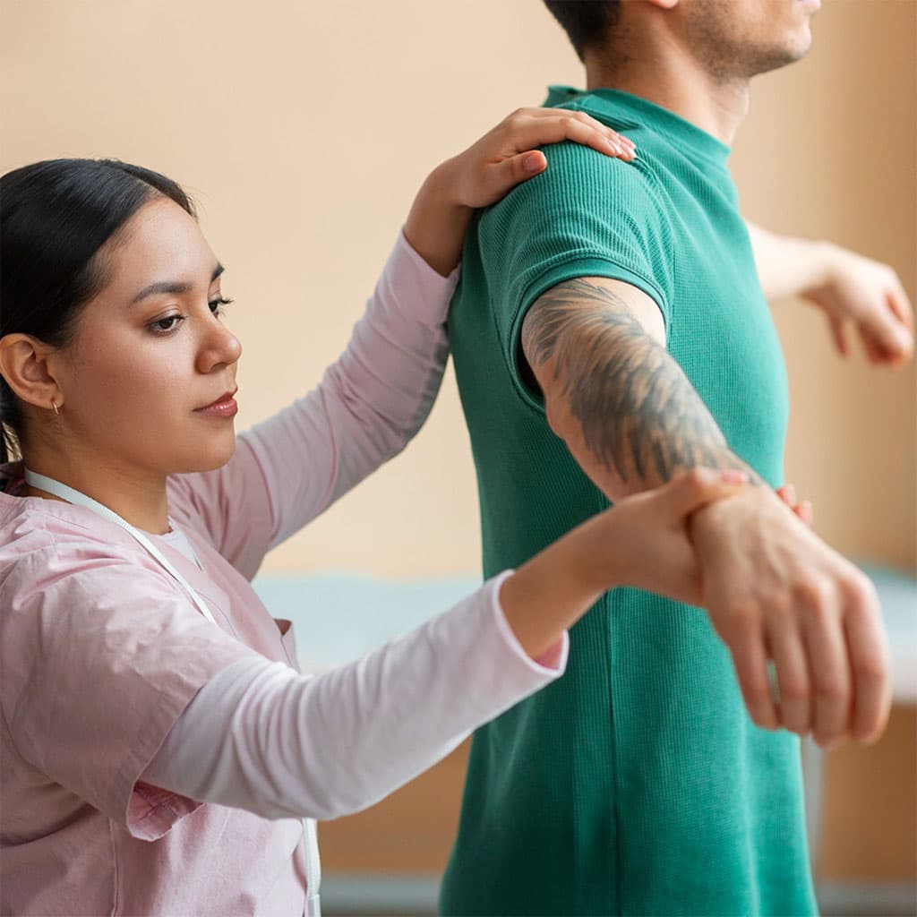 Clinician assessing a patient's shoulder injury