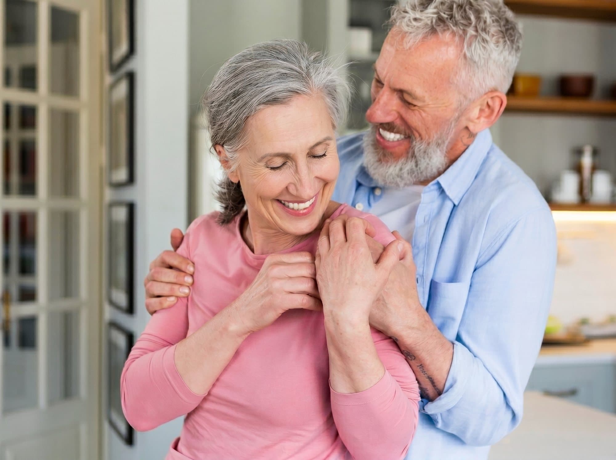 Healthy senior couple smiling together at home