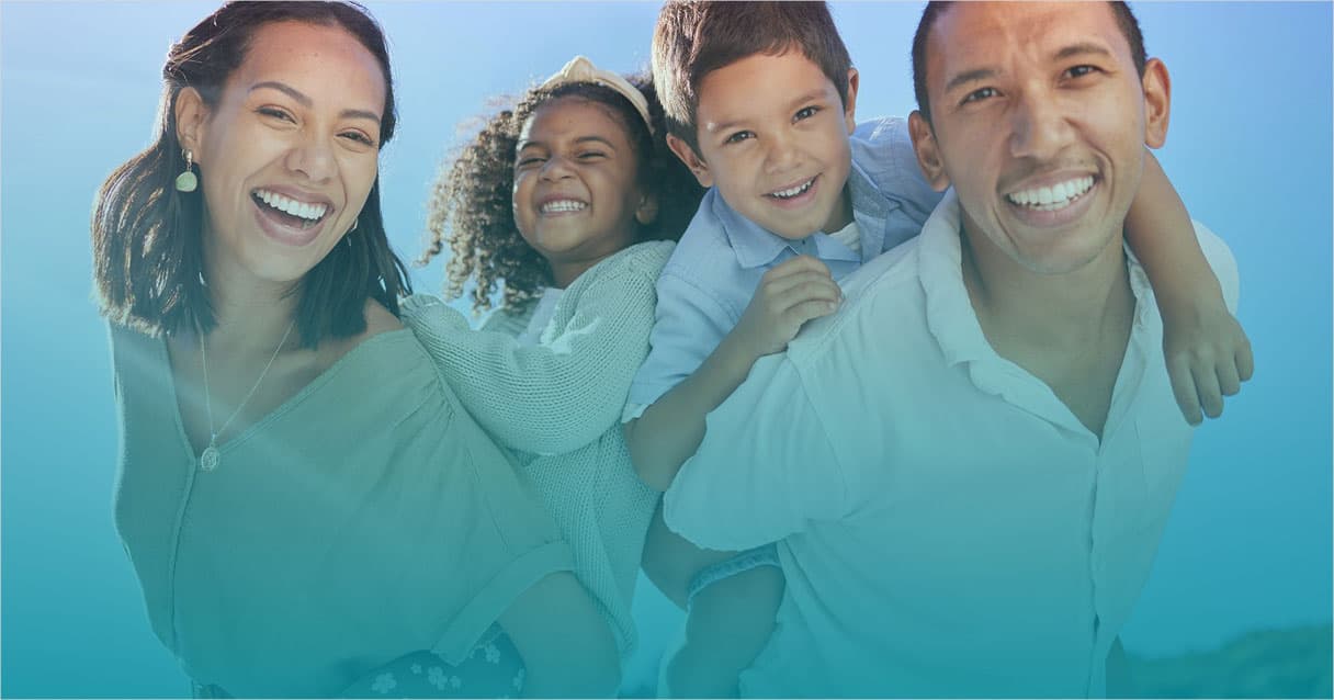 Parents and two children laughing together outdoors